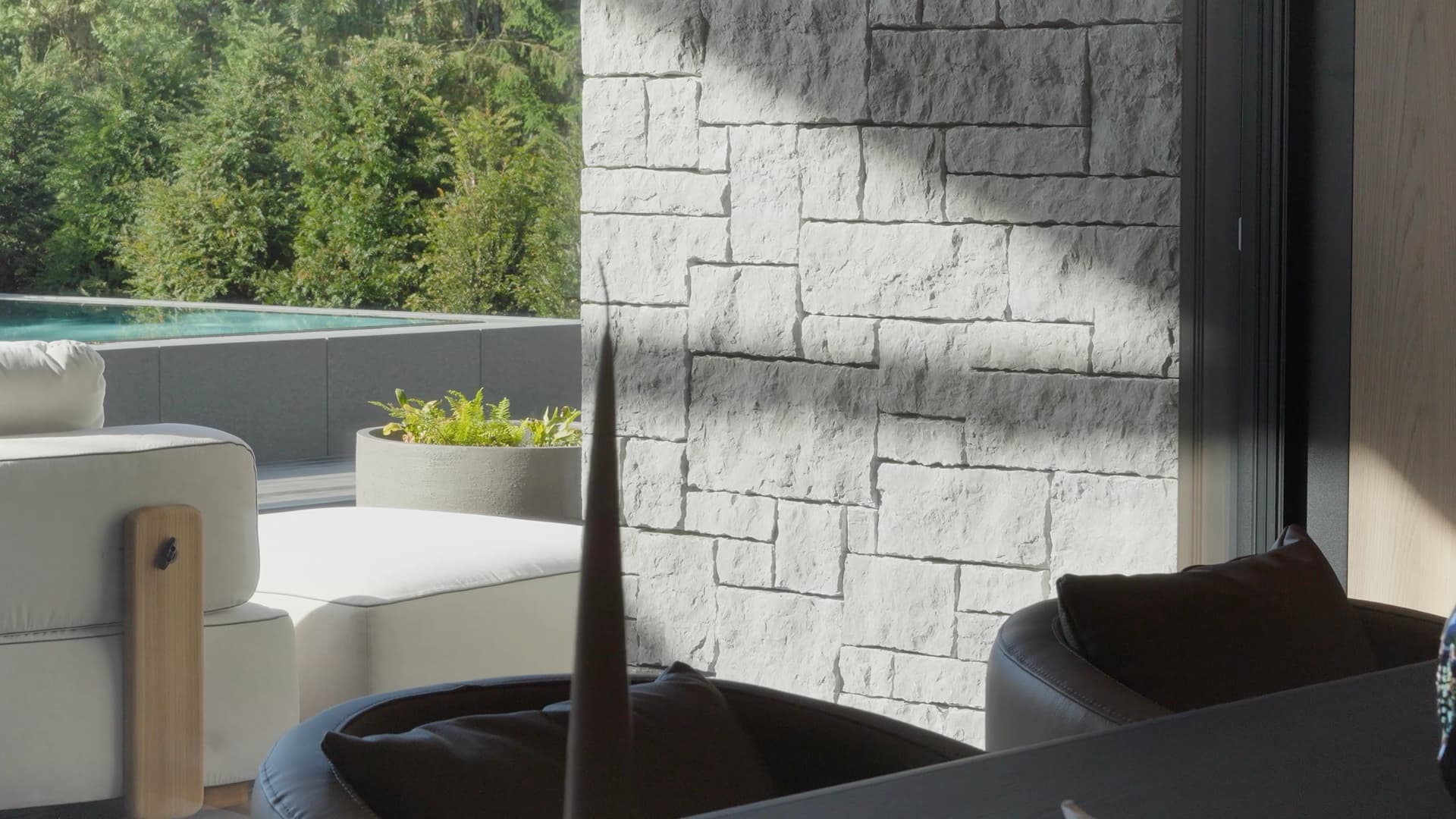 Stone wall and pool – still from the film